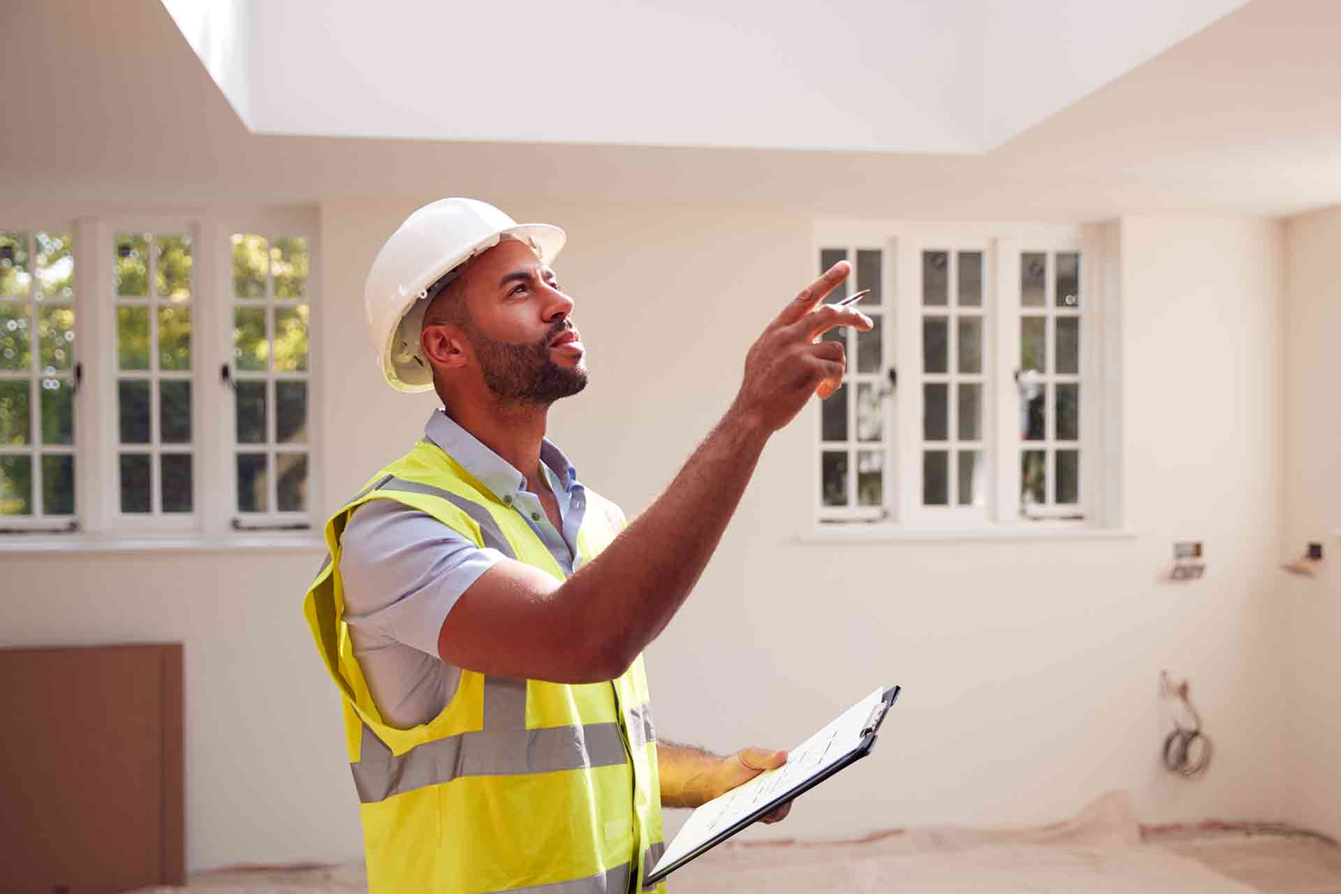 Third Party Wall Surveyors Newbury reviewing plans between two parties during a dispute